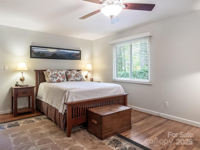 bedroom with baseboards, ceiling fan, and light wood-type flooring