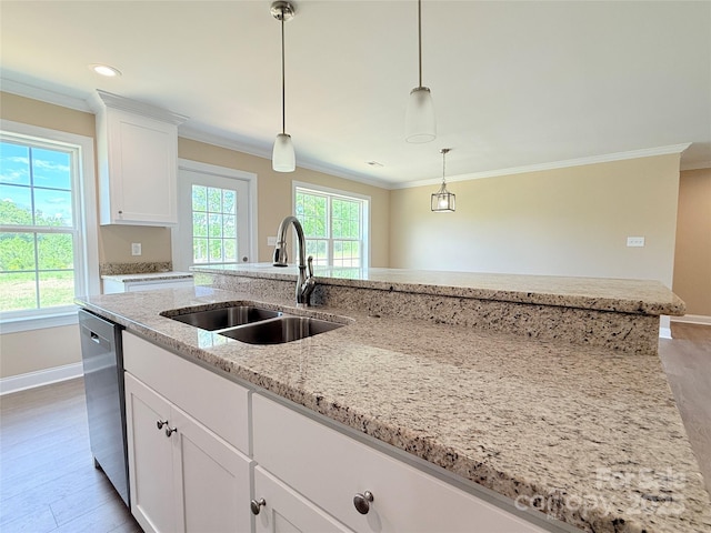 kitchen with baseboards, a sink, crown molding, and dishwasher