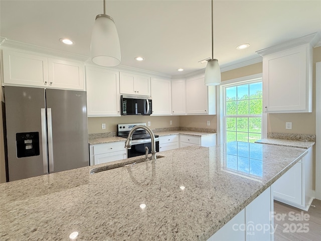 kitchen featuring a sink, appliances with stainless steel finishes, white cabinets, and light stone countertops