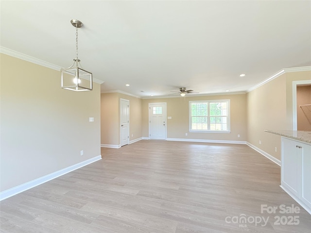 unfurnished living room featuring baseboards, ornamental molding, ceiling fan, and light wood-type flooring