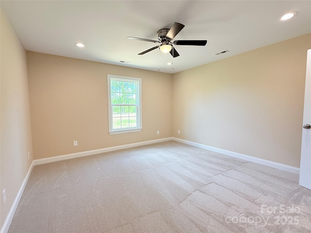 empty room featuring visible vents, baseboards, ceiling fan, and light carpet