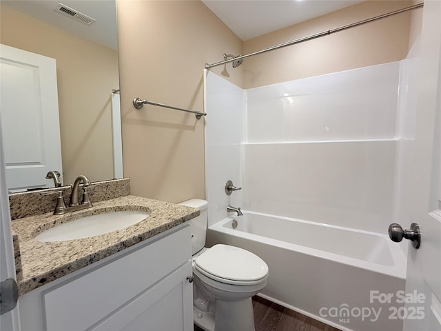 full bath featuring vanity, toilet, bathing tub / shower combination, wood finished floors, and visible vents
