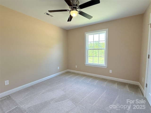 empty room featuring a ceiling fan, baseboards, visible vents, and light carpet