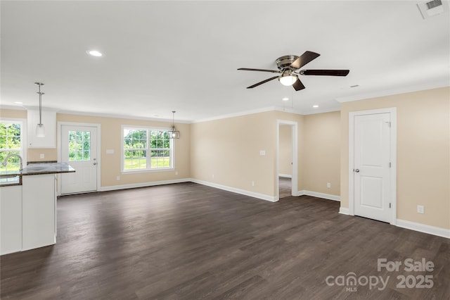 3650 Sentry Rd, Lancaster, SC 29720 - unfurnished living room featuring healthy amount of natural light, ceiling fan, recessed lighting, ornamental molding, and dark wood-style floors