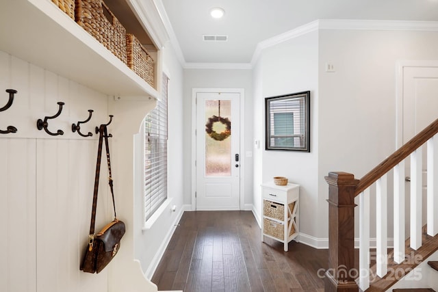 mudroom with dark wood-type flooring, crown molding, and baseboards