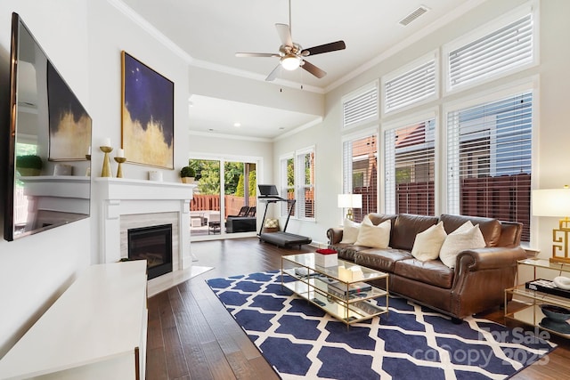 living area featuring crown molding, dark wood-style floors, ceiling fan, a fireplace, and recessed lighting