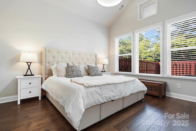 bedroom featuring baseboards, dark wood-style flooring, and high vaulted ceiling