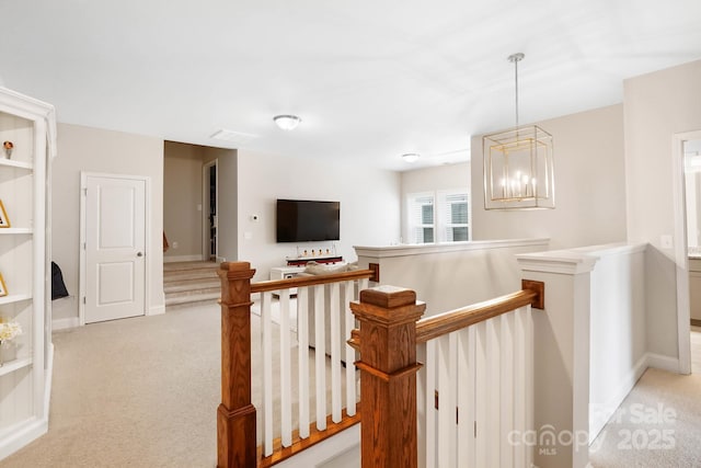 hall with an upstairs landing, light carpet, a chandelier, and baseboards