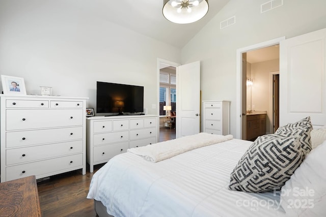 bedroom with dark wood-style floors, high vaulted ceiling, and ensuite bathroom