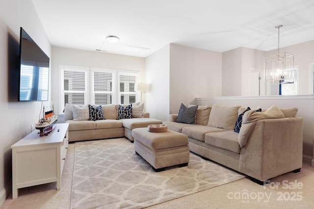 living area with a chandelier and baseboards