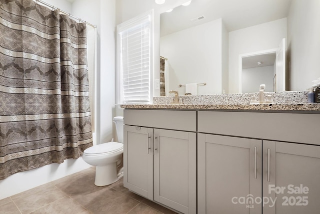 full bathroom with toilet, double vanity, shower / tub combo with curtain, and tile patterned floors