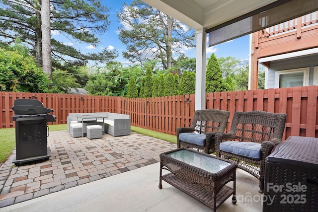 view of patio featuring outdoor lounge area, a fenced backyard, and a grill