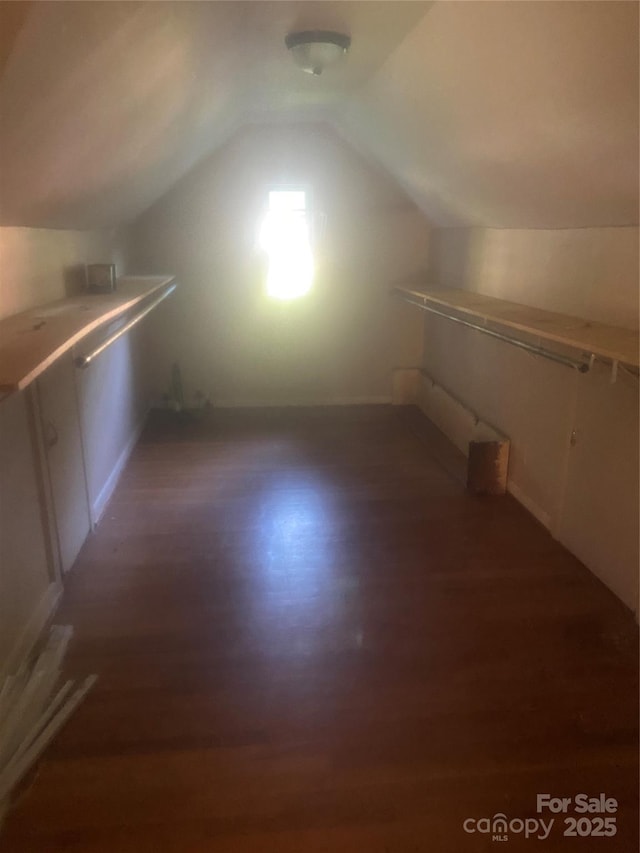 spacious closet with wood finished floors and lofted ceiling