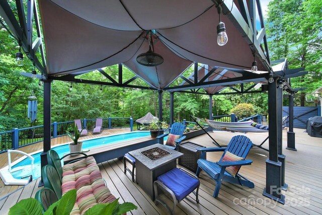8524 Quarters Ln, Mint Hill, NC 28227 - wooden terrace featuring a fire pit and view of wooded area