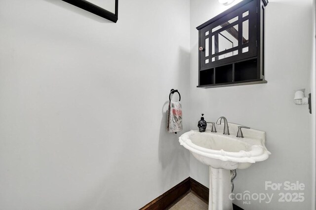 8524 Quarters Ln, Mint Hill, NC 28227 - bathroom with baseboards and a sink