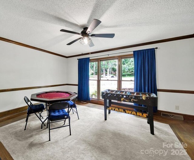 8524 Quarters Ln, Mint Hill, NC 28227 - recreation room with ornamental molding, wood finished floors, a ceiling fan, a textured ceiling, and baseboards