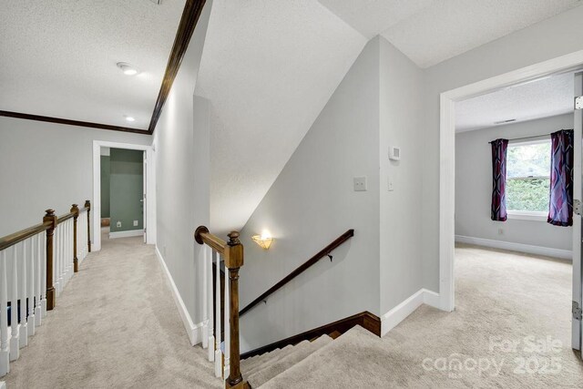 8524 Quarters Ln, Mint Hill, NC 28227 - hallway featuring an upstairs landing, light colored carpet, a textured ceiling, and baseboards