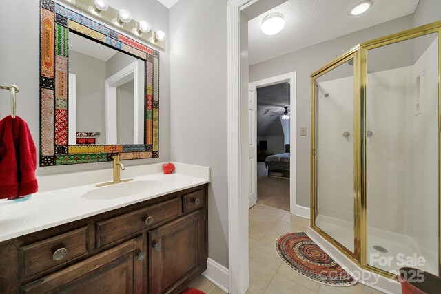 8524 Quarters Ln, Mint Hill, NC 28227 - ensuite bathroom featuring a stall shower, tile patterned floors, vanity, and baseboards