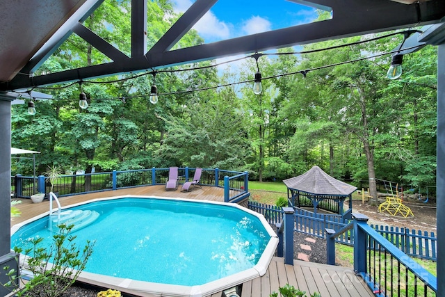8524 Quarters Ln, Mint Hill, NC 28227 - view of swimming pool featuring a gazebo, a wooden deck, and view of scattered trees