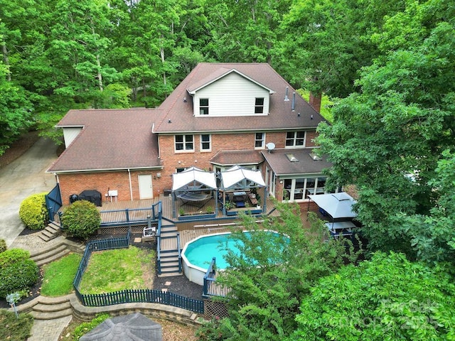 8524 Quarters Ln, Mint Hill, NC 28227 - back of house with a deck, brick siding, stairway, and an outdoor pool