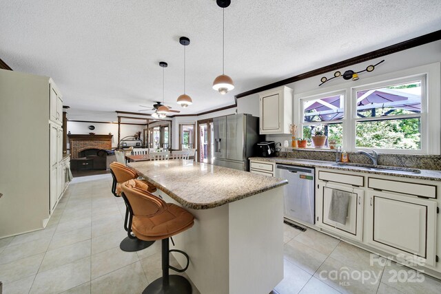 8524 Quarters Ln, Mint Hill, NC 28227 - kitchen with stainless steel appliances, a sink, light tile patterned flooring, crown molding, and a kitchen island