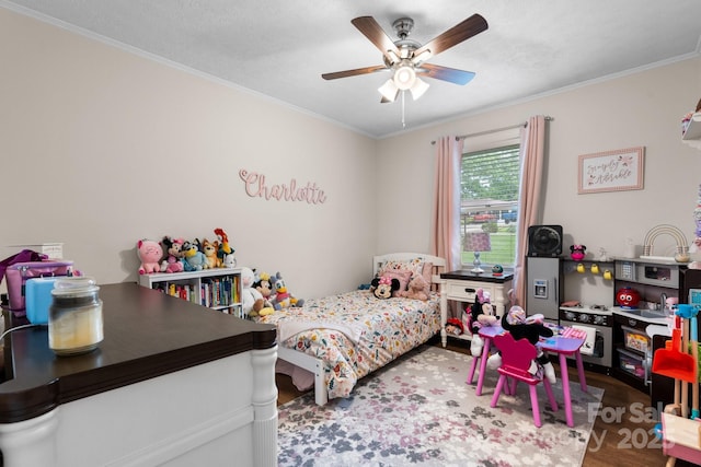 bedroom with crown molding, ceiling fan, and wood finished floors