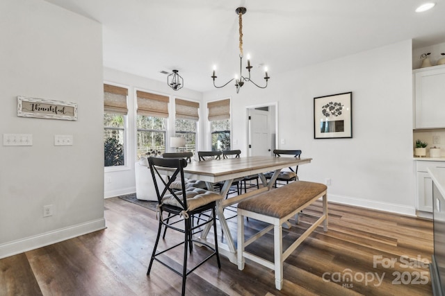 dining room with baseboards, dark wood-type flooring, and a notable chandelier