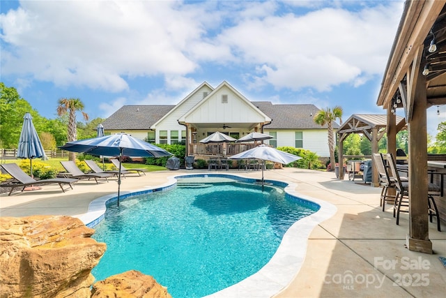 view of swimming pool featuring a gazebo, a fenced in pool, and a patio