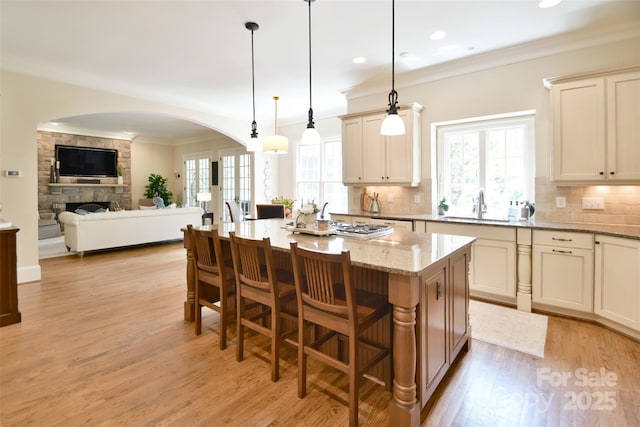5827 Rileys Ridge Rd, Charlotte, NC 28226 - kitchen with a sink, arched walkways, tasteful backsplash, light stone countertops, and ornamental molding