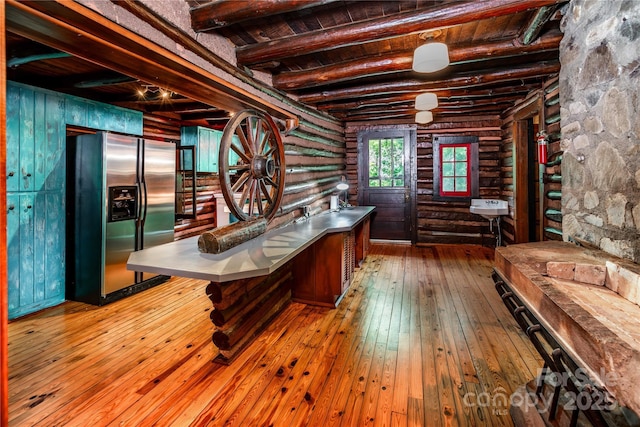 office featuring rustic walls, wood-type flooring, beam ceiling, and wooden ceiling