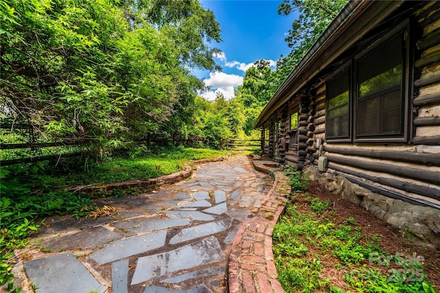 view of yard featuring fence and a patio