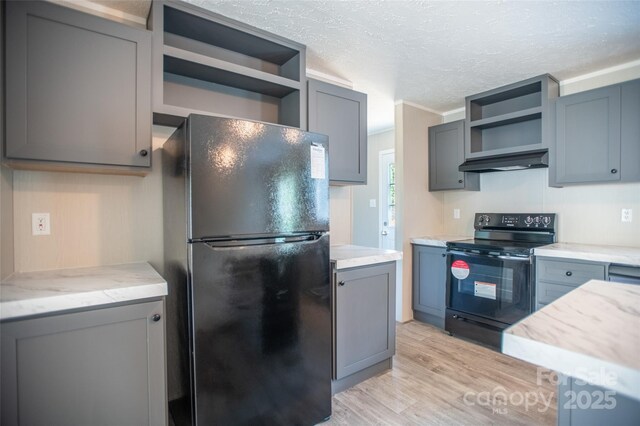 kitchen featuring under cabinet range hood, a textured ceiling, open shelves, and black appliances