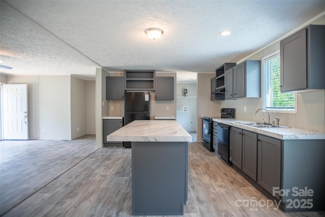 kitchen with gray cabinets, open shelves, a sink, and black appliances