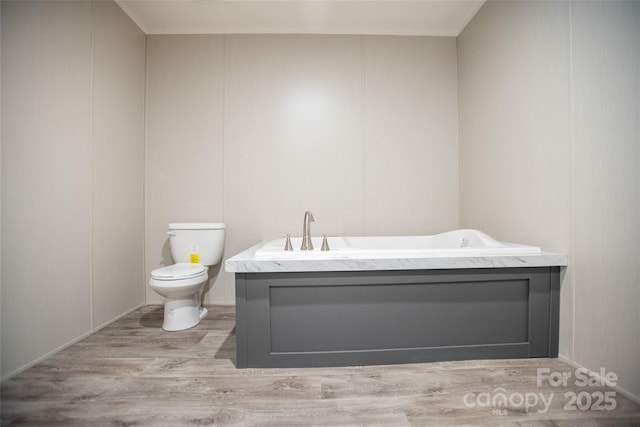 bathroom with wood finished floors and toilet