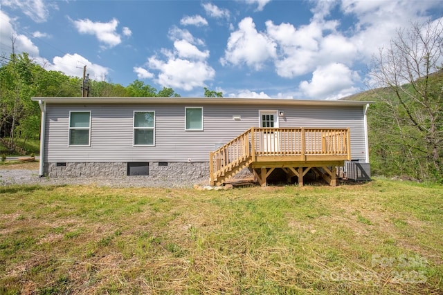 back of house featuring a lawn, crawl space, central air condition unit, and a deck