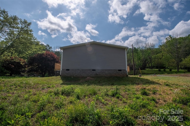 view of side of home with crawl space