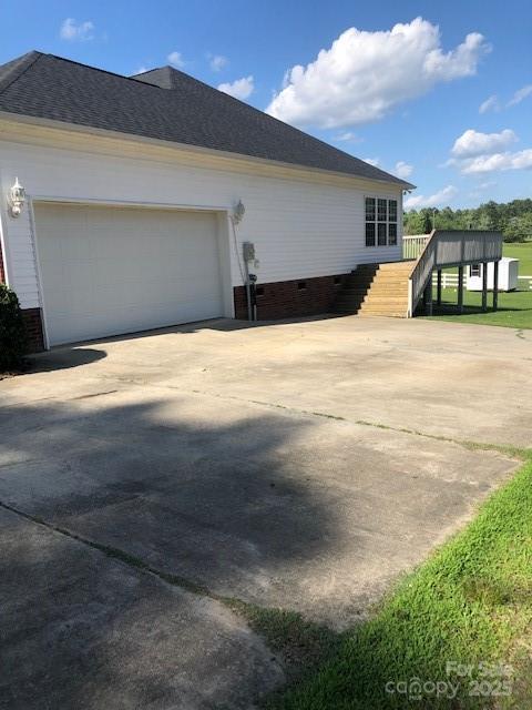 2547 Bill Thompson Rd, Lancaster, SC 29720 - view of side of home featuring stairway, driveway, a garage, and a shingled roof