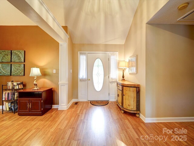 2547 Bill Thompson Rd, Lancaster, SC 29720 - entrance foyer featuring light wood-style floors, baseboards, high vaulted ceiling, and decorative columns