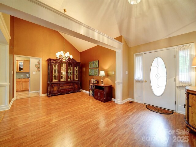 2547 Bill Thompson Rd, Lancaster, SC 29720 - foyer entrance with vaulted ceiling, light wood-style flooring, a chandelier, and baseboards