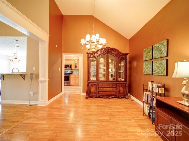 2547 Bill Thompson Rd, Lancaster, SC 29720 - dining room with a chandelier, light wood-style floors, high vaulted ceiling, and baseboards