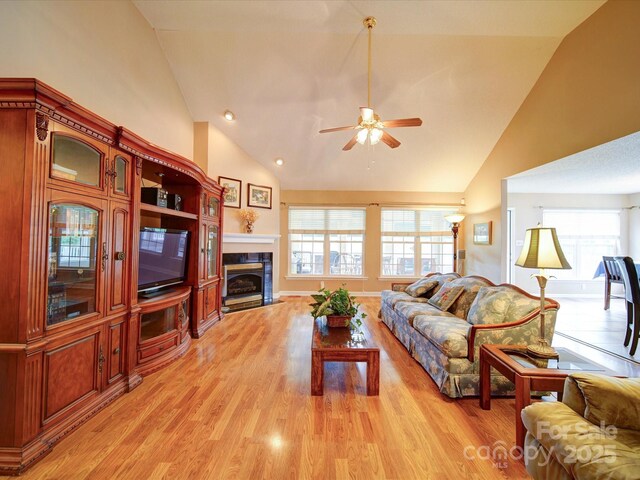 2547 Bill Thompson Rd, Lancaster, SC 29720 - living room featuring high vaulted ceiling, a ceiling fan, healthy amount of natural light, a fireplace, and light wood-style floors
