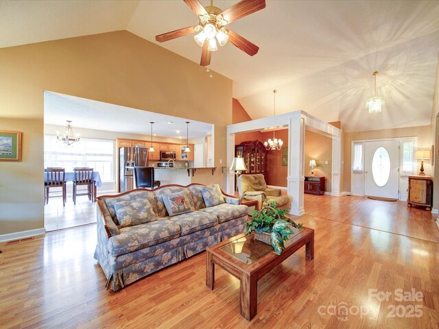 2547 Bill Thompson Rd, Lancaster, SC 29720 - living area featuring a chandelier, healthy amount of natural light, light wood finished floors, a ceiling fan, and high vaulted ceiling