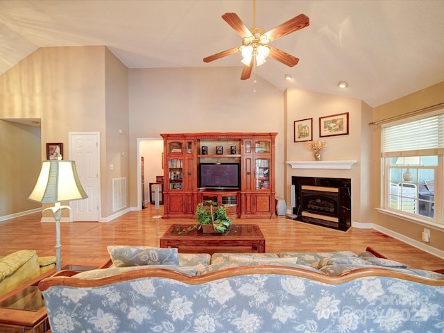 2547 Bill Thompson Rd, Lancaster, SC 29720 - living room with wood finished floors, a ceiling fan, a fireplace with flush hearth, baseboards, and high vaulted ceiling