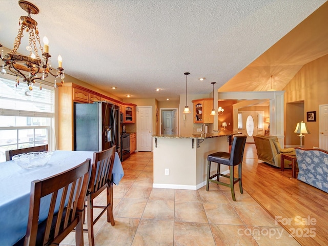 2547 Bill Thompson Rd, Lancaster, SC 29720 - kitchen featuring black appliances, glass insert cabinets, a peninsula, a textured ceiling, and a chandelier