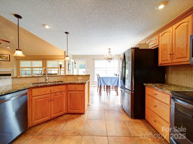 2547 Bill Thompson Rd, Lancaster, SC 29720 - kitchen featuring stainless steel appliances, a sink, backsplash, a textured ceiling, and pendant lighting