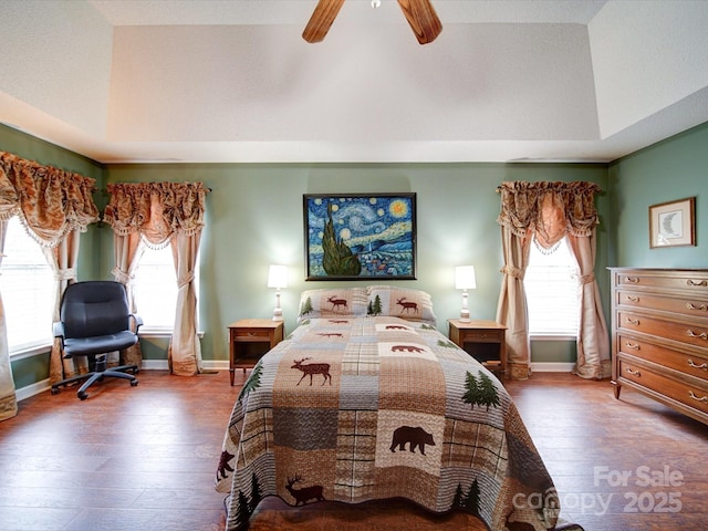 2547 Bill Thompson Rd, Lancaster, SC 29720 - bedroom with hardwood / wood-style flooring, multiple windows, a ceiling fan, and a tray ceiling