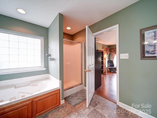2547 Bill Thompson Rd, Lancaster, SC 29720 - bathroom with a stall shower, a whirlpool tub, and a textured ceiling