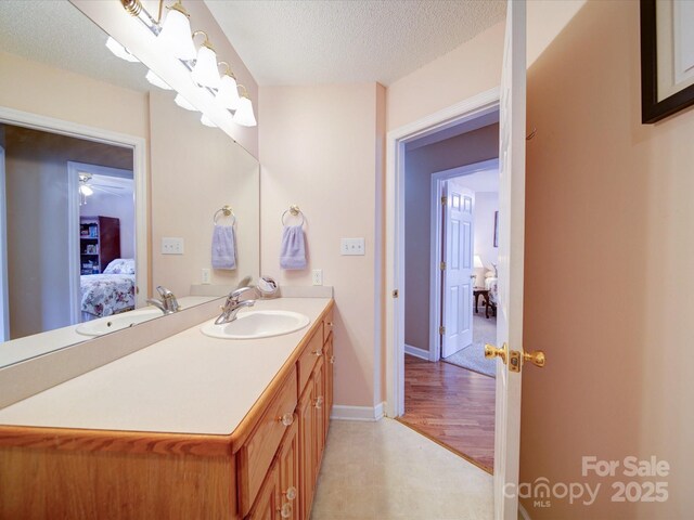 2547 Bill Thompson Rd, Lancaster, SC 29720 - bathroom featuring connected bathroom, vanity, a textured ceiling, baseboards, and a ceiling fan