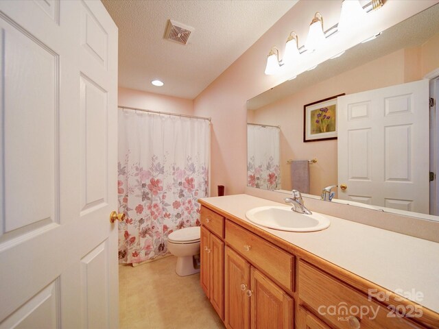2547 Bill Thompson Rd, Lancaster, SC 29720 - full bathroom featuring vanity, toilet, a textured ceiling, a shower with shower curtain, and recessed lighting