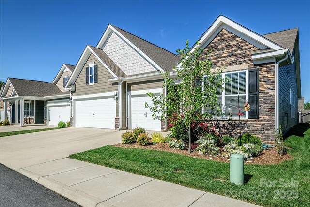 70 Cameo Dr, Flat Rock, NC 28731 - craftsman house featuring stone siding, a garage, driveway, and a front yard